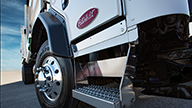 Peterbilt Model 520 Vocational White Truck Low Rear 3/4 Cab Closeup Featuring Wheel Step and Door on Dry Mud Flats Background - Thumbnail